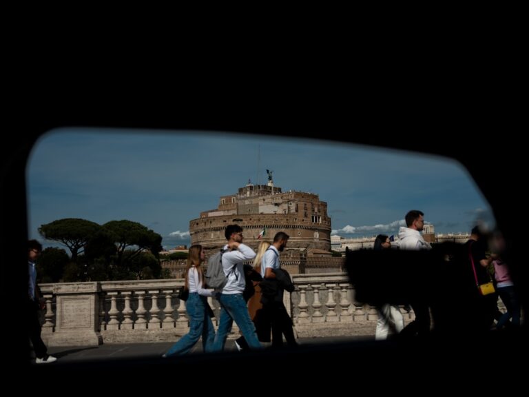 A moment in motion — Castel Sant’Angelo in Rome, viewed through the window of a passing car. Tourists drift by, unaware of the frame they’re part of. A blend of stillness, structure, and street life in one cinematic glance.