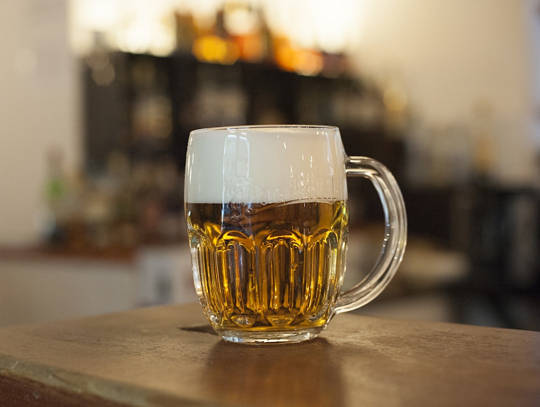 A mug of beer on a bar.