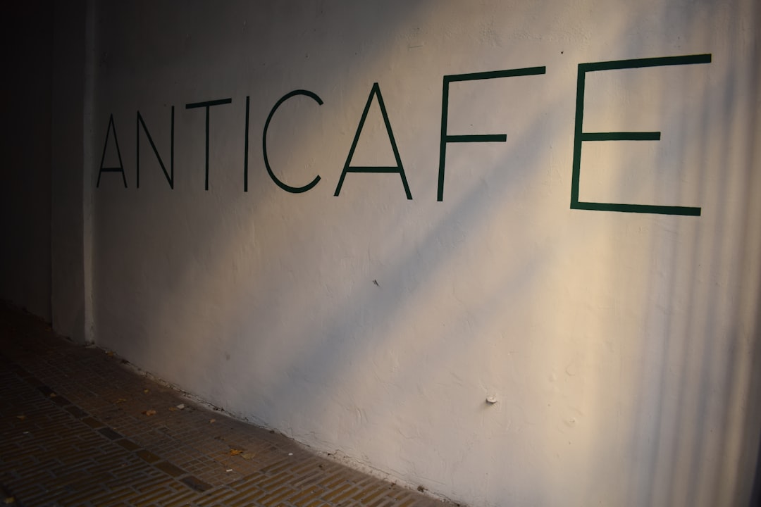 The word anticafe written on a white wall.