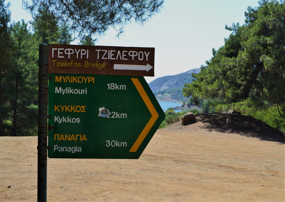 Signage with a shotgun pellet hole, Cyprus